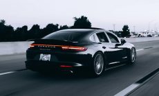running black Porsche sedan