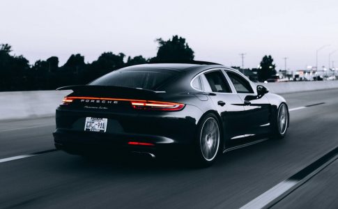 running black Porsche sedan